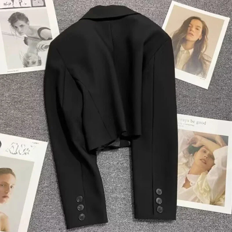 Black coat on a textured surface with printed images of people in the background