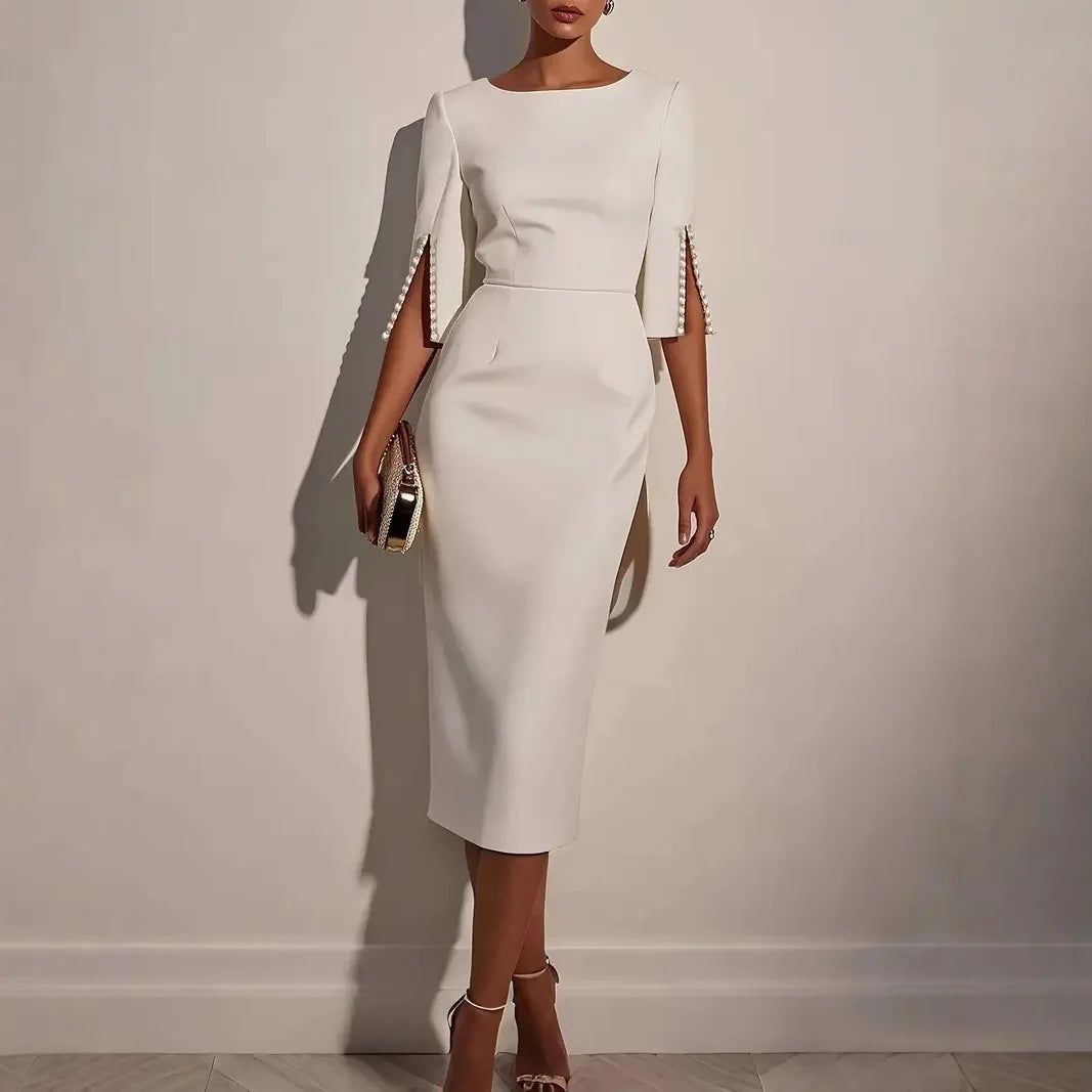White dress with decorative sleeves against a plain background