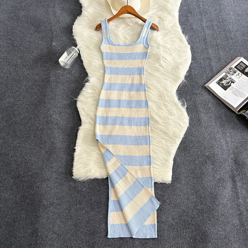 Striped dress on a hanger against a textured gray background