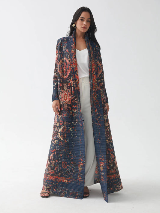 Woman wearing a long, patterned coat on a white background