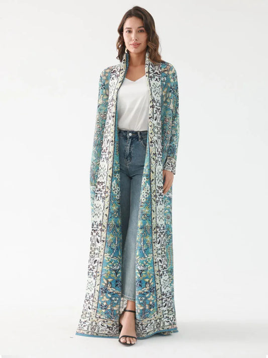 Woman wearing a long, patterned coat over a white top and jeans on a white background