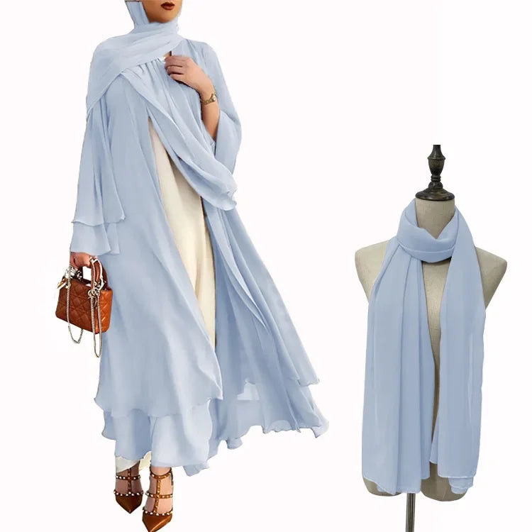 Light blue hijab draped over a person and on a mannequin against a white background