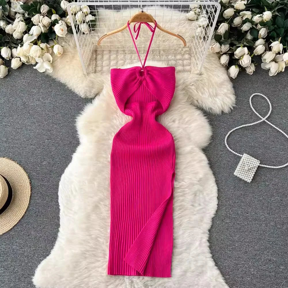 Pink ribbed dress on a hanger with decorative elements on a gray surface