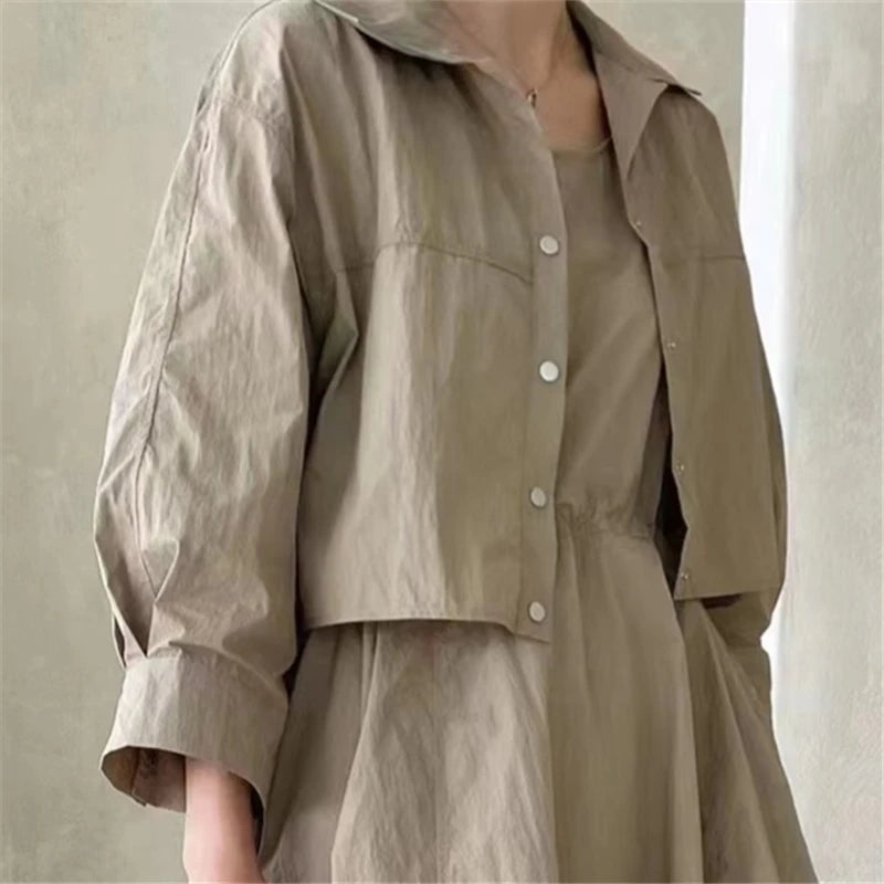 Beige jacket and dress set on a neutral background
