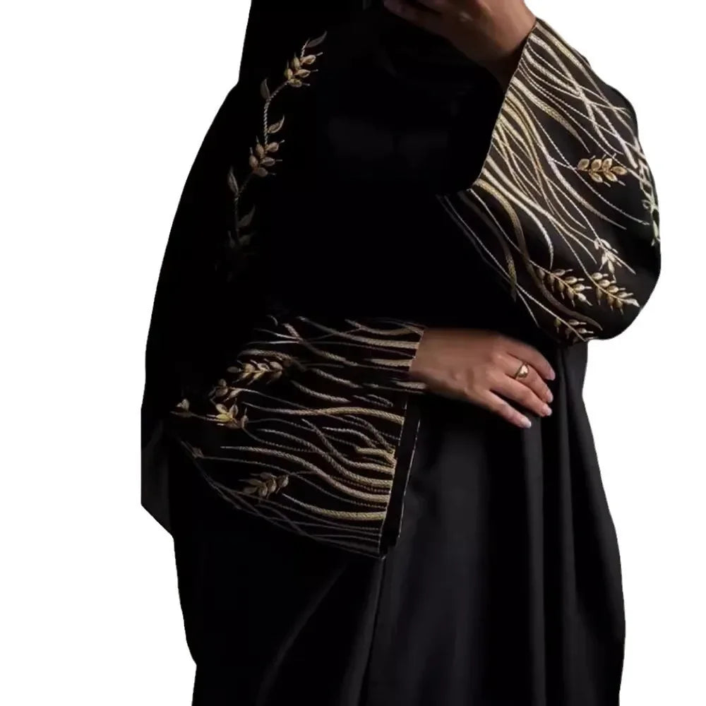 Black garment with gold embroidery on a white background