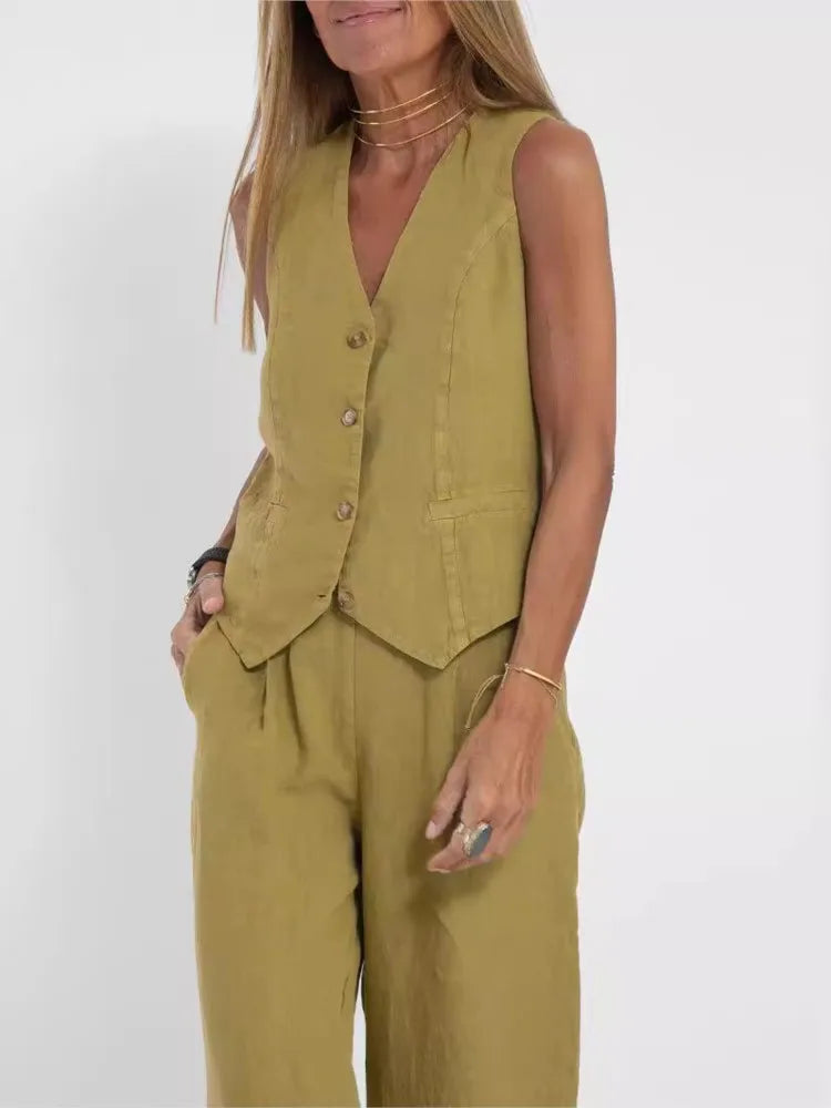 Woman wearing a green sleeveless top and pants set on a white background