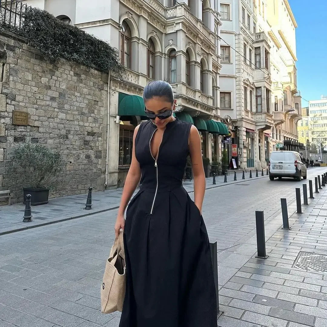 Woman in a black dress walking on a city street