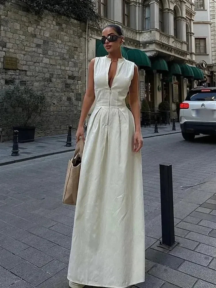 Woman in a white dress standing on a city street