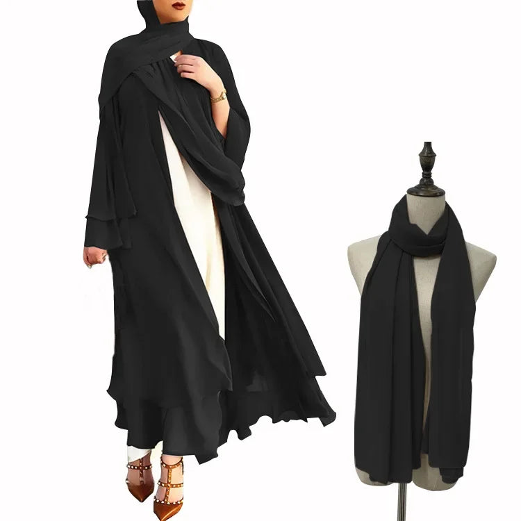 Black abaya with white inner garment and black scarf on a mannequin