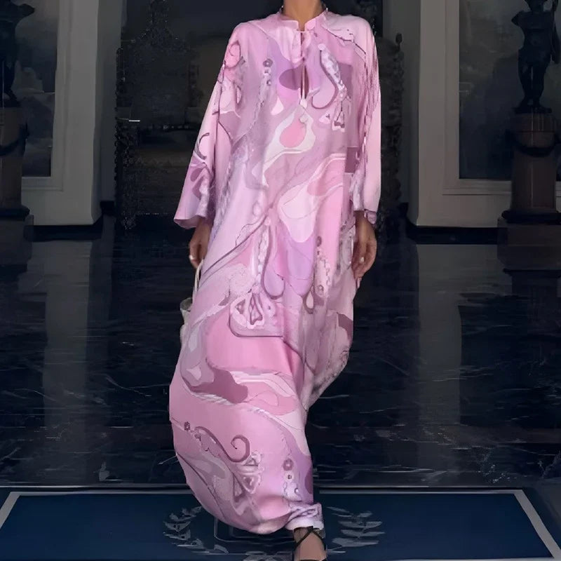 Person wearing a pink dress with a floral pattern in an indoor setting