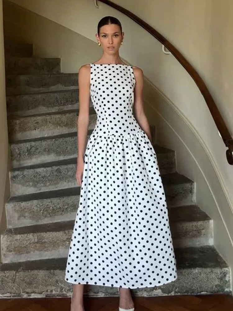 Woman in a polka dot dress standing on a staircase