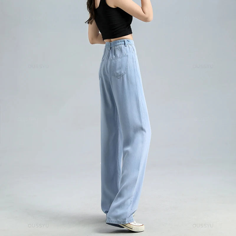 Light blue jeans worn by a person on a gray background