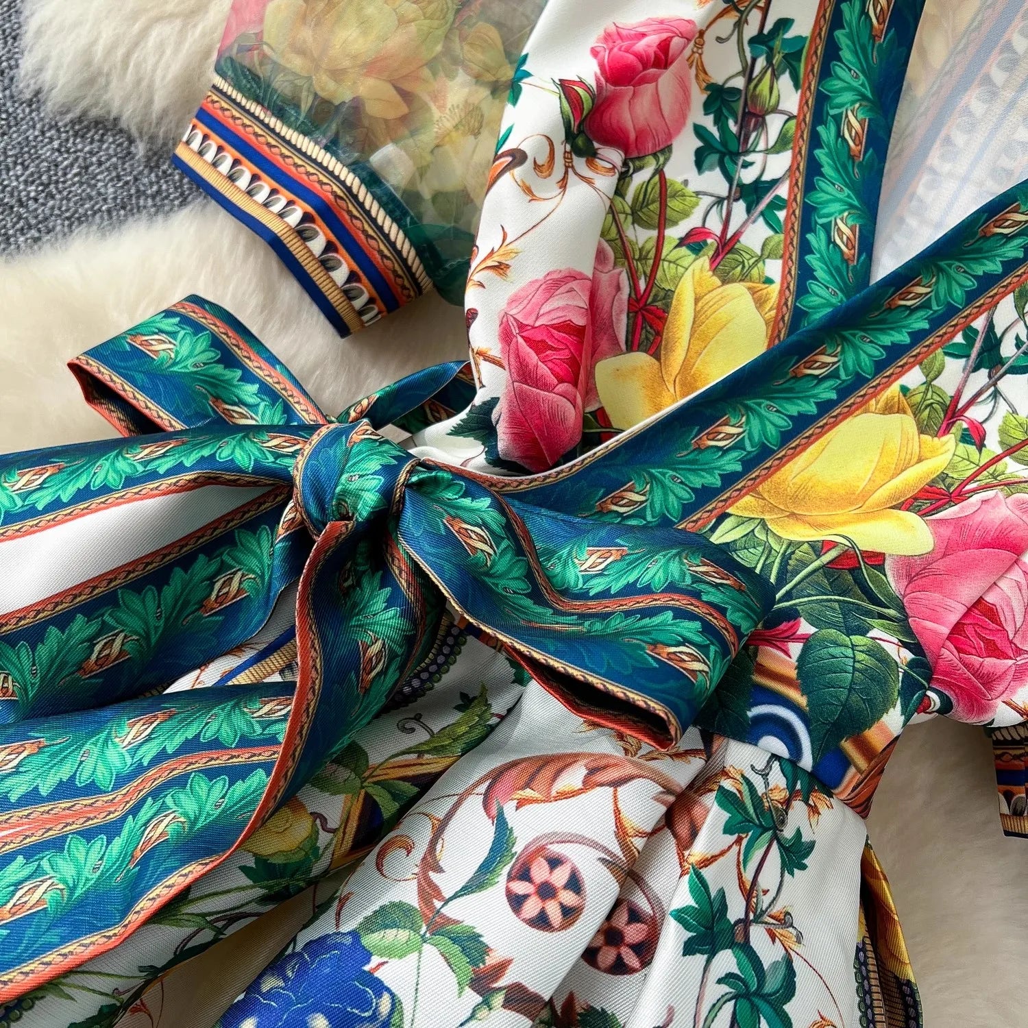 Colorful fabric with floral and geometric patterns on a textured surface