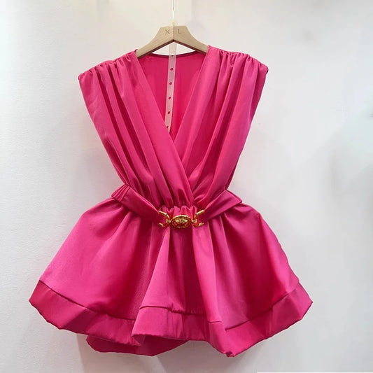 Pink dress with a gold belt on a hanger against a white background