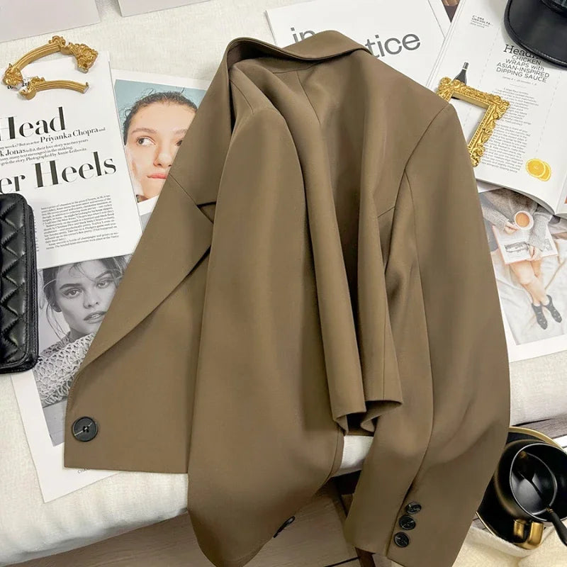 Brown coat on a surface with magazines underneath