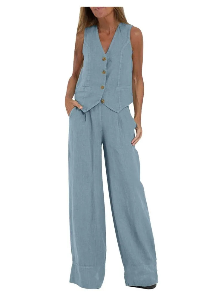 Woman wearing a light blue vest and wide-leg pants on a white background