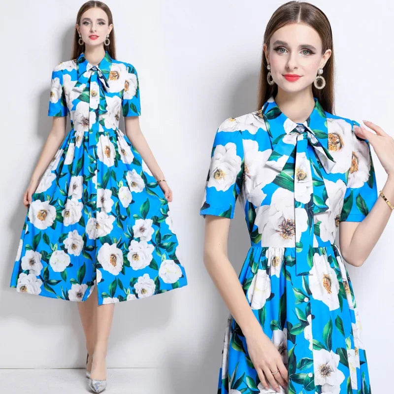 Woman wearing a blue floral dress with a white background