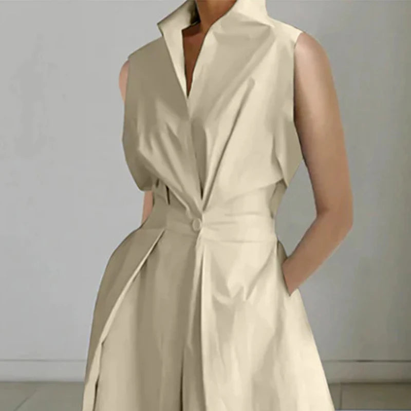 Beige sleeveless dress worn by a person on a plain background