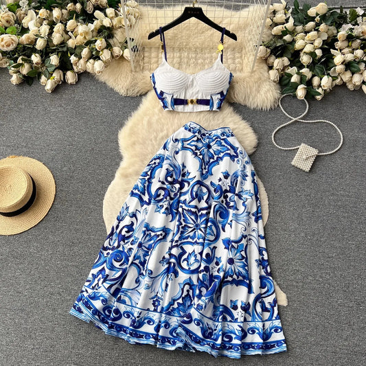 Blue and white patterned dress with a hat and flowers on a gray surface
