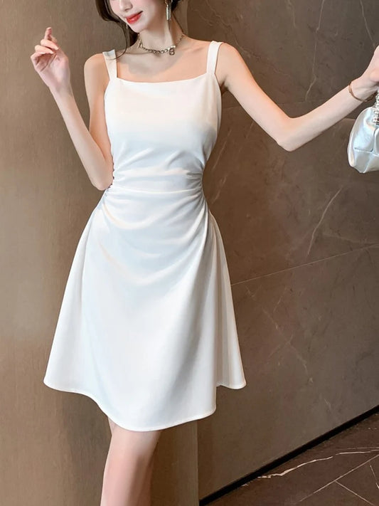 Woman wearing a white dress against a brown background