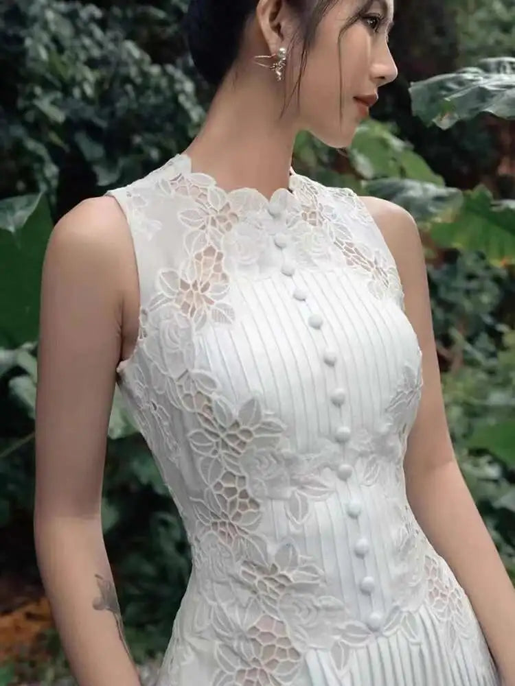 Woman wearing a white lace dress with a green leafy background