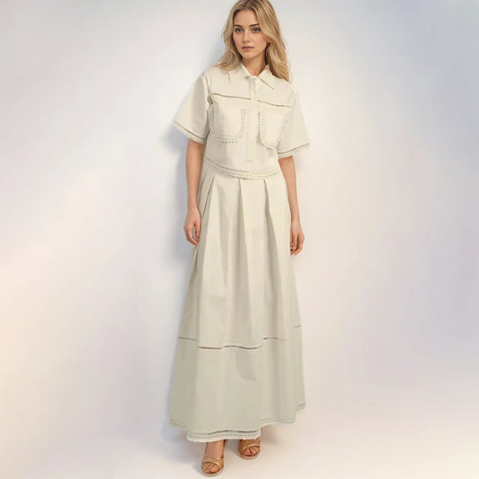 Woman wearing a light-colored dress with a jacket on a white background
