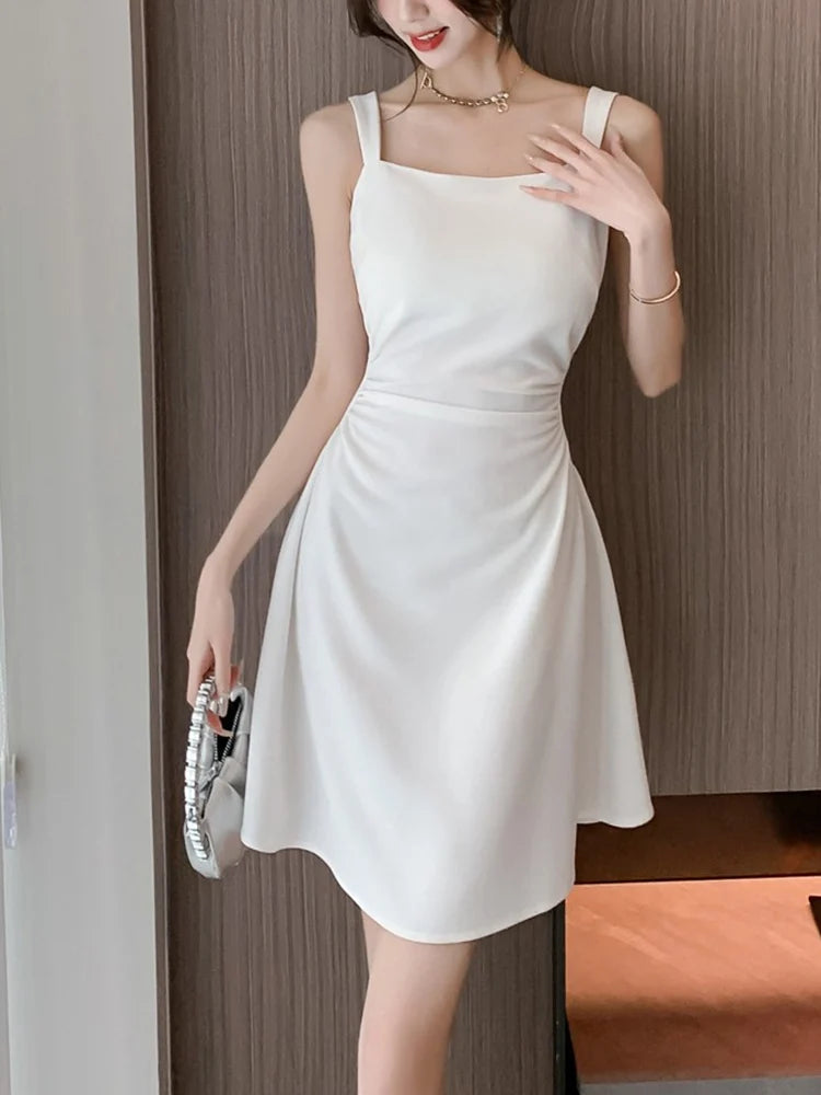 Woman wearing a white dress with a neutral background